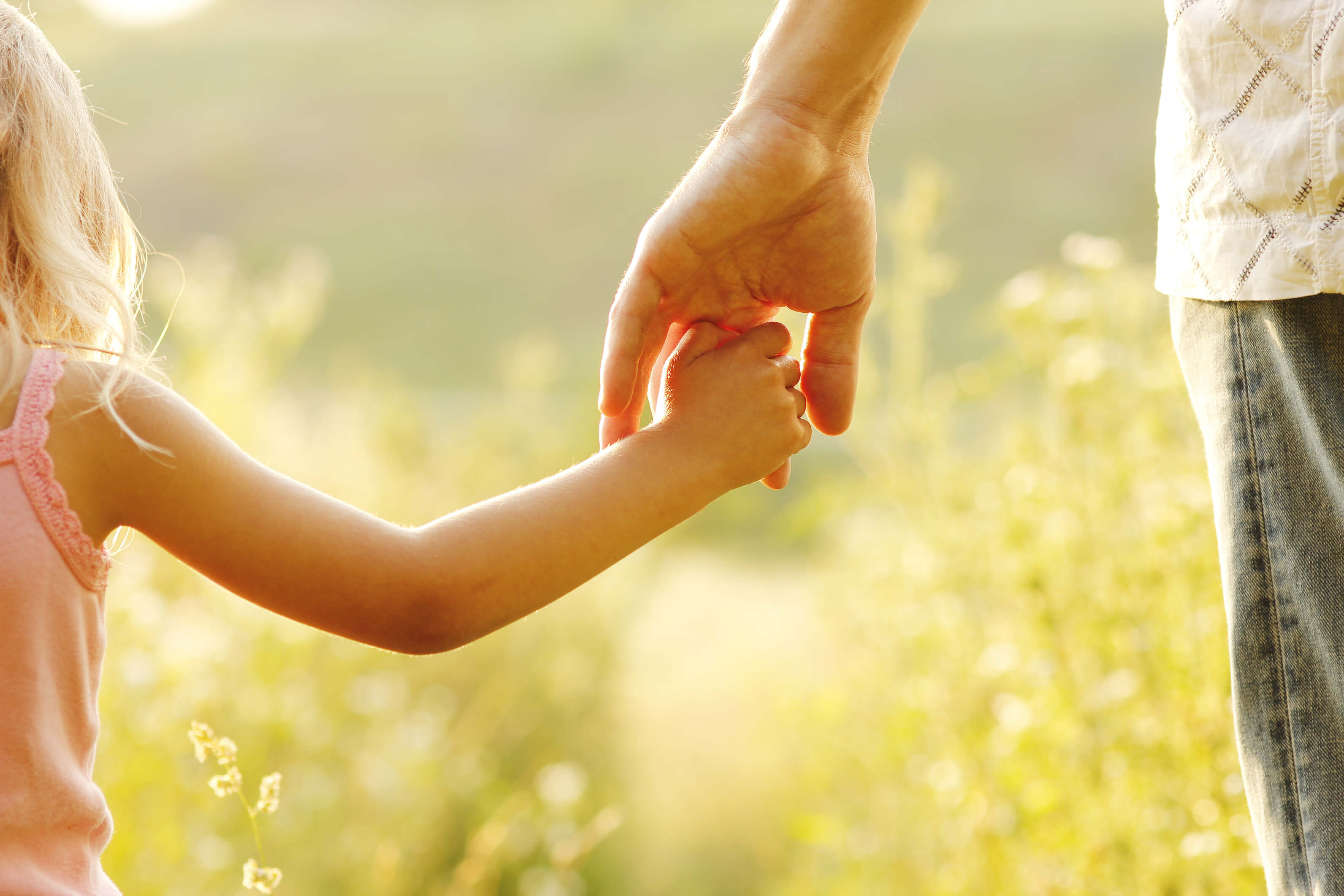 Parent holding child’s hand - child custody advocate