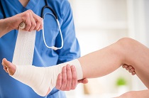Medical personal wrapping a foot in a bandage