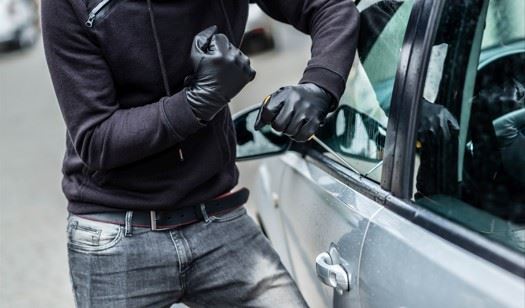 man breaking into a car